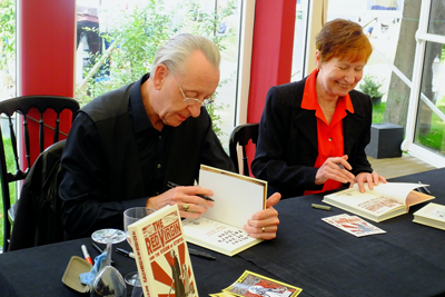 Mary and Bryan Talbot signing copies of the Red Virgin and the Vision of Utopia that Mary wrote and Bryan drew